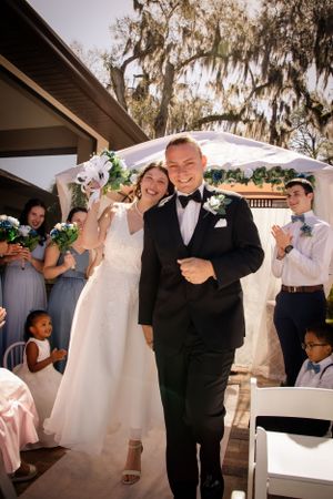 Wedding celebration sequence showing joyful dancing moments under Spanish moss trees.