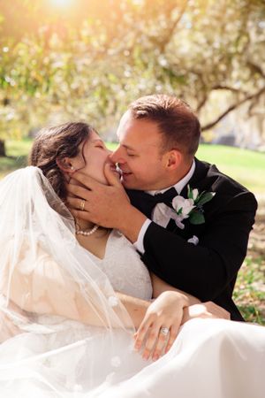Intimate wedding kiss sequence photographed in golden afternoon light.