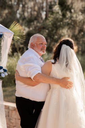 Father-daughter dance captured in sequence photos at outdoor wedding reception.