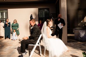 Wedding reception guests dancing and celebrating in an indoor venue.
