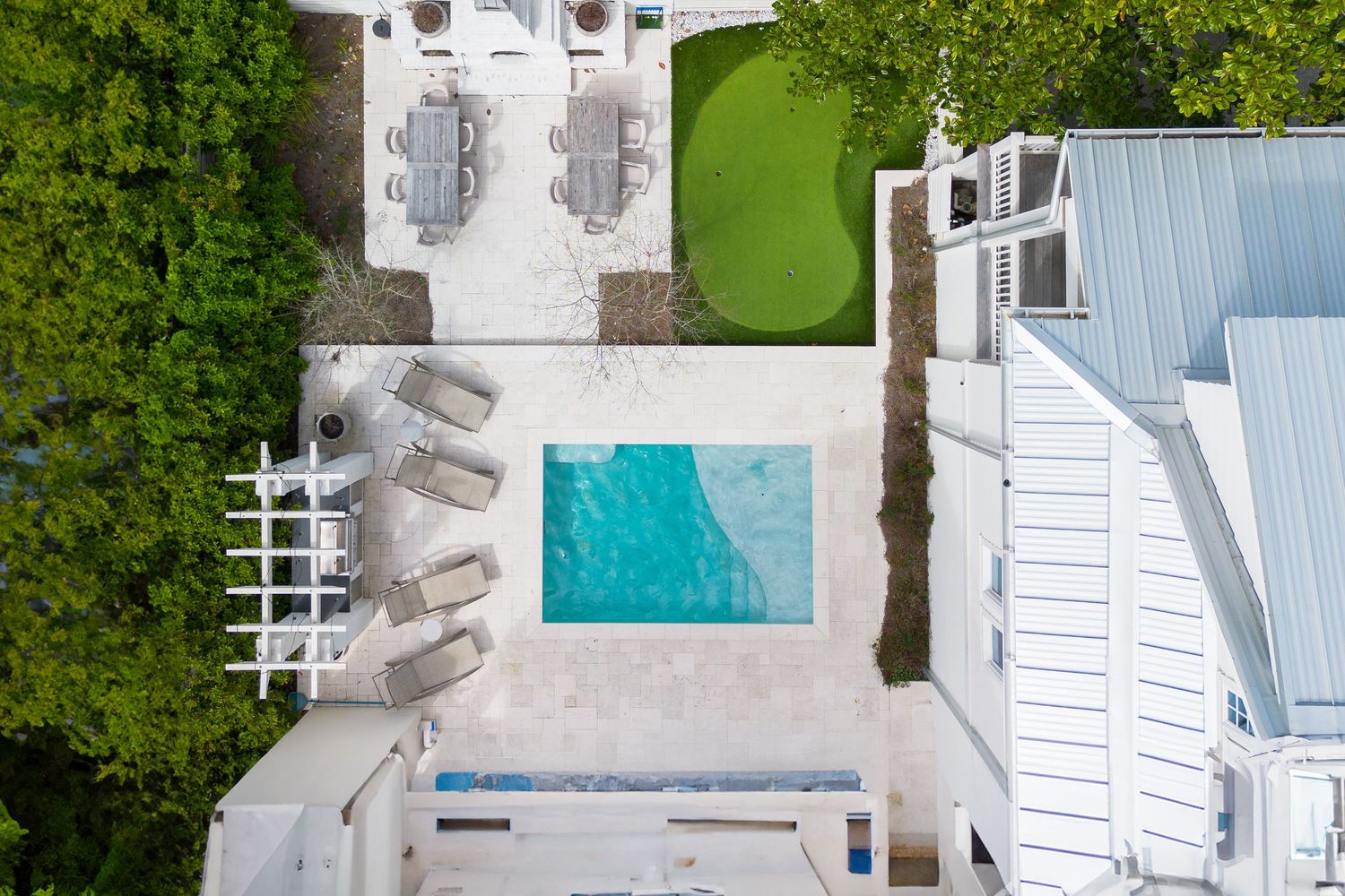 Aerial view of a stunning pool in 30A FL, captured by drone for real estate photography.