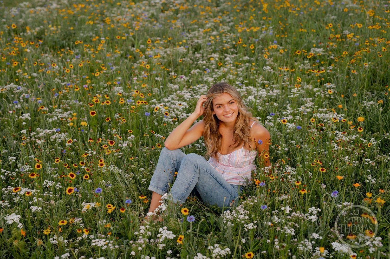 Golden hour portrait in a wildflower field with natural, candid posing.