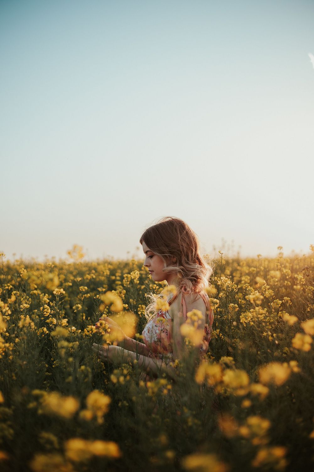 girl in tall yellow flowers