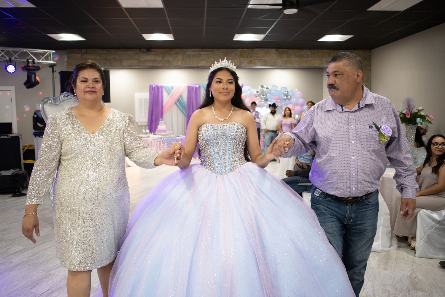 A special moment at a quinceañera celebration with family members in formal attire.