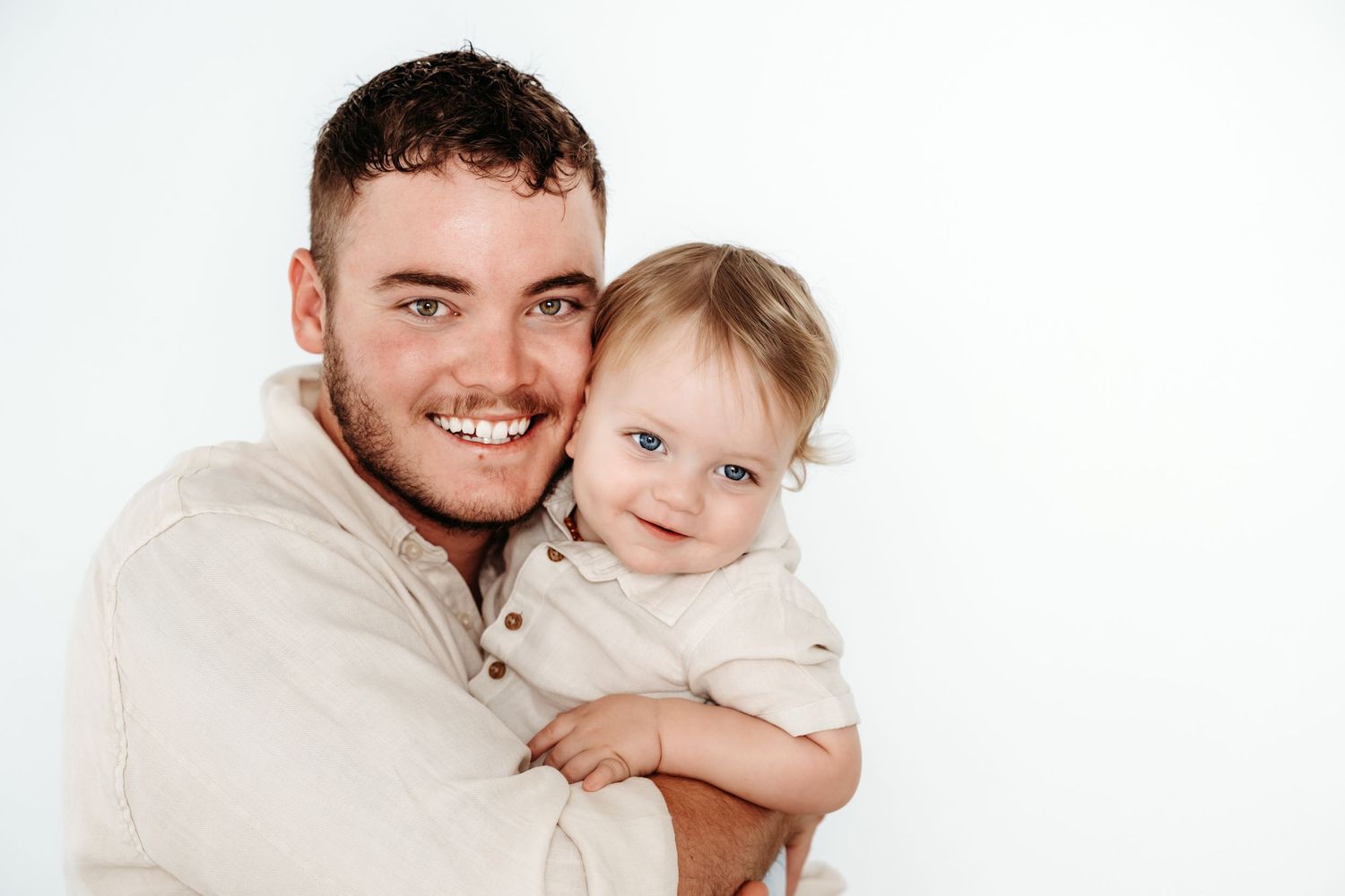 A warm family portrait against a clean white background.