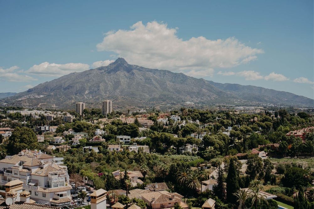 Mountain landscape view of a coastal city with modern buildings and residential areas.