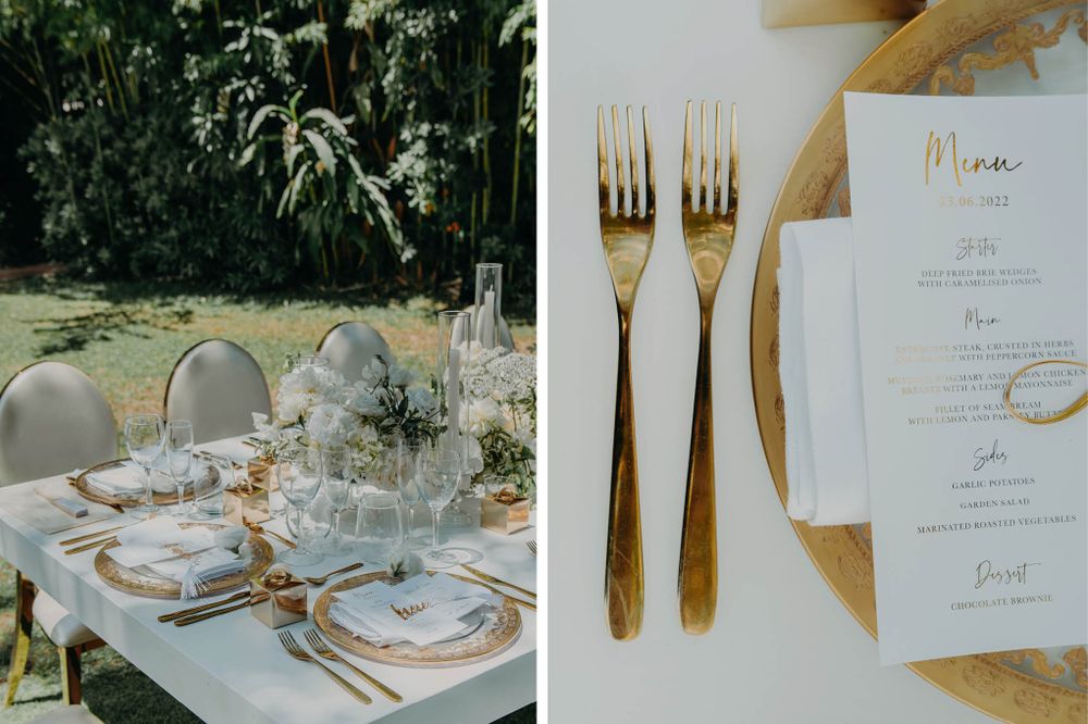 Elegant table settings with gold utensils and printed menus at an outdoor wedding reception.