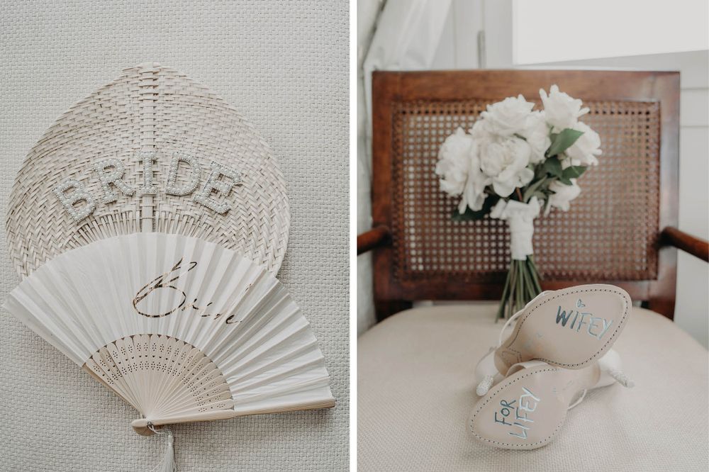 Wedding accessories including decorative fan and white floral bouquet on wooden furniture.