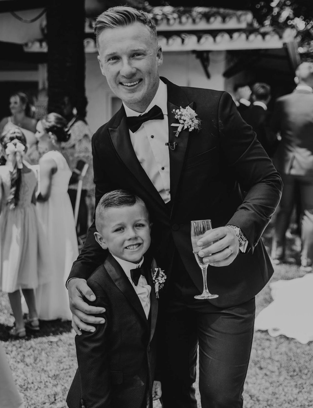 A black and white wedding celebration portrait capturing a joyful moment.