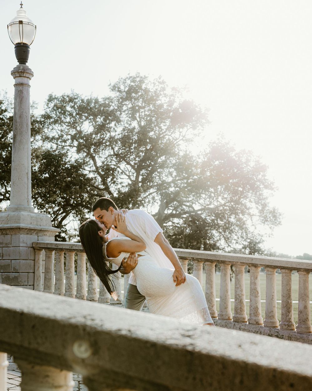 Wedding photography sequence captured on a stone balustrade during golden hour.
