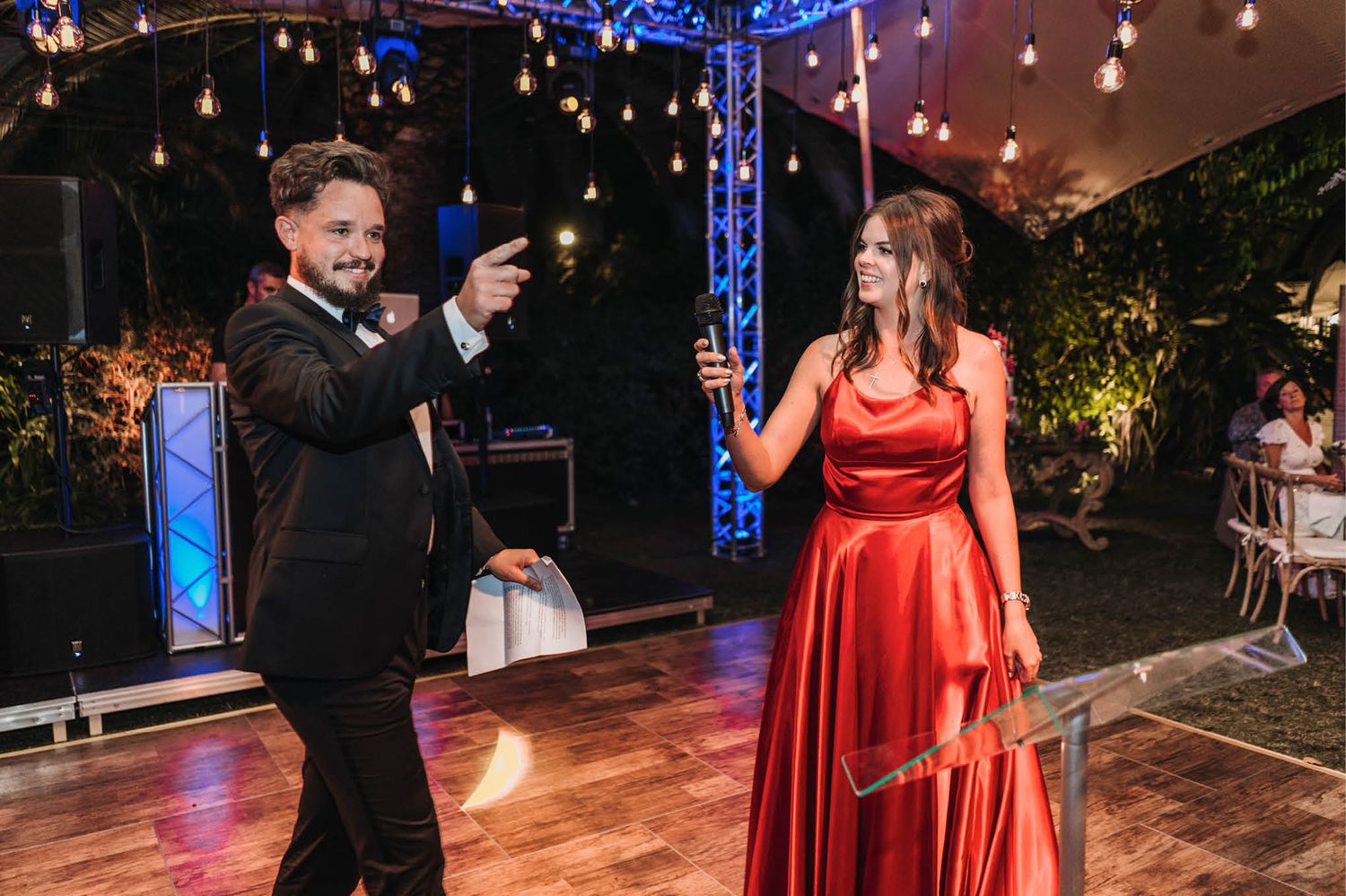 Entertainment performance on dance floor with blue lighting and staging equipment.