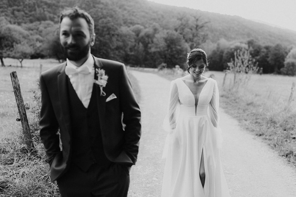 Black and white panoramic wedding photo collage showing outdoor ceremony and reception moments in a rustic setting.