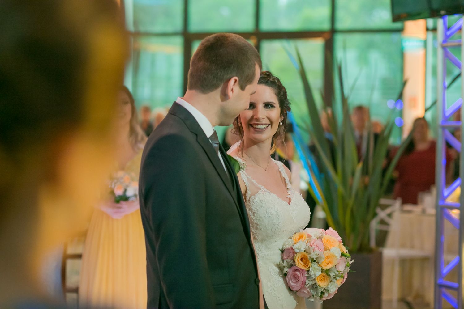 Candid wedding moment captured in warm lighting with florals and decor.