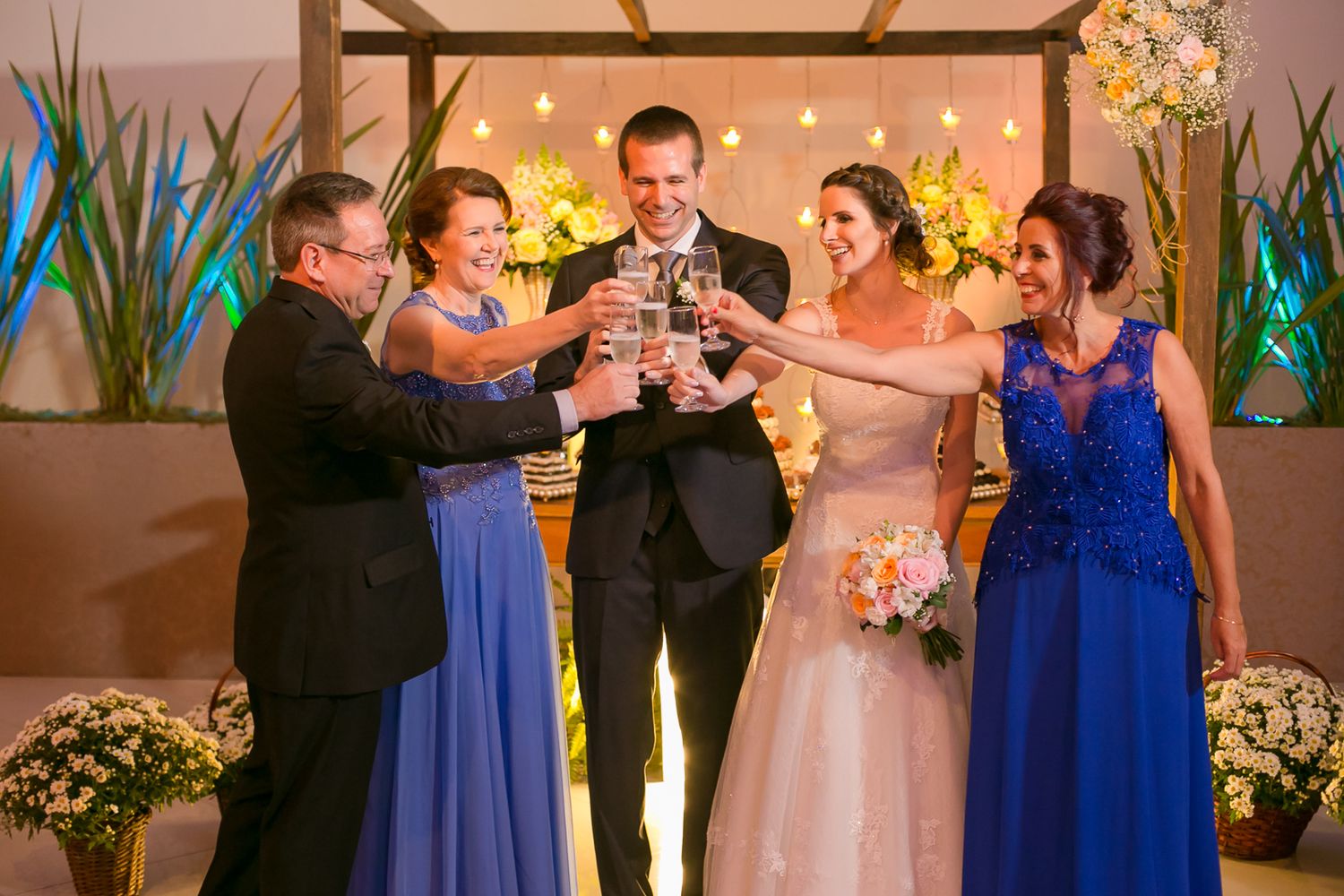 Wedding party raises glasses in a celebratory toast during the reception.