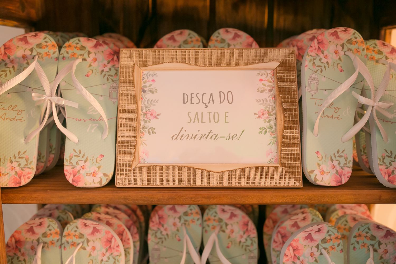 Rows of decorative flip flops with floral patterns and bows displayed on wooden shelves.