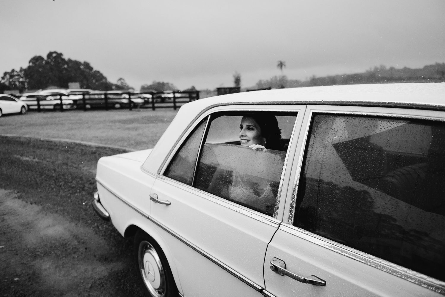 Classic white Mercedes-Benz car parked in a countryside setting.