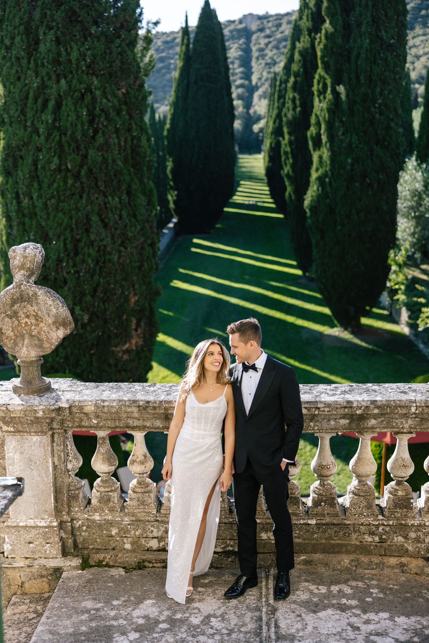 Wedding couple enjoying a boat ride on Lake Como with sunglasses and formal attire.