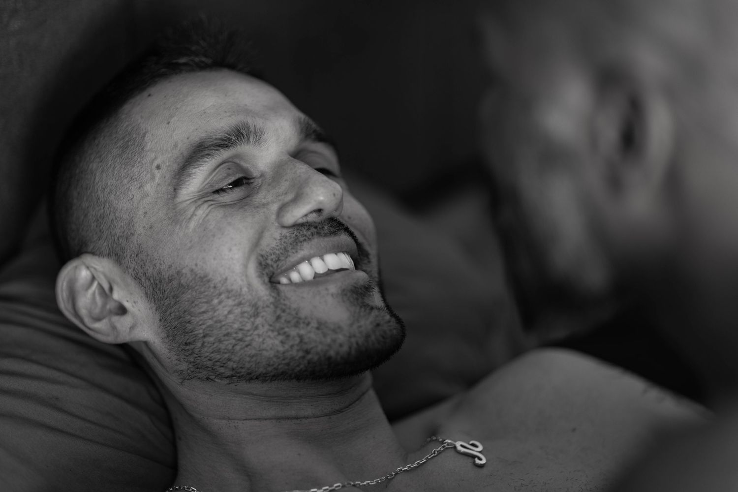 Photograph of gay couple in bed captured by Los Angeles boudoir photographer.