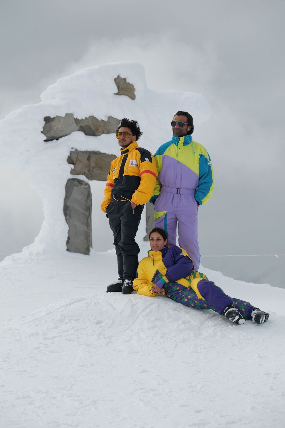 Group in colorful retro ski outfits standing on snowy slope against cloudy sky.
Whistler Blackcomb