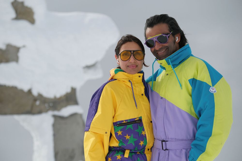 Pair in bright retro ski outfits posing against snowy mountain backdrop.
Whistler Blackcomb