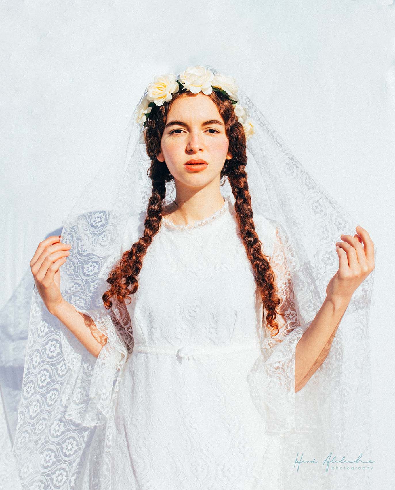 Portrait of a woman in White, Natural light. Portrait Photography session. Outdoor photography. flower ornament.