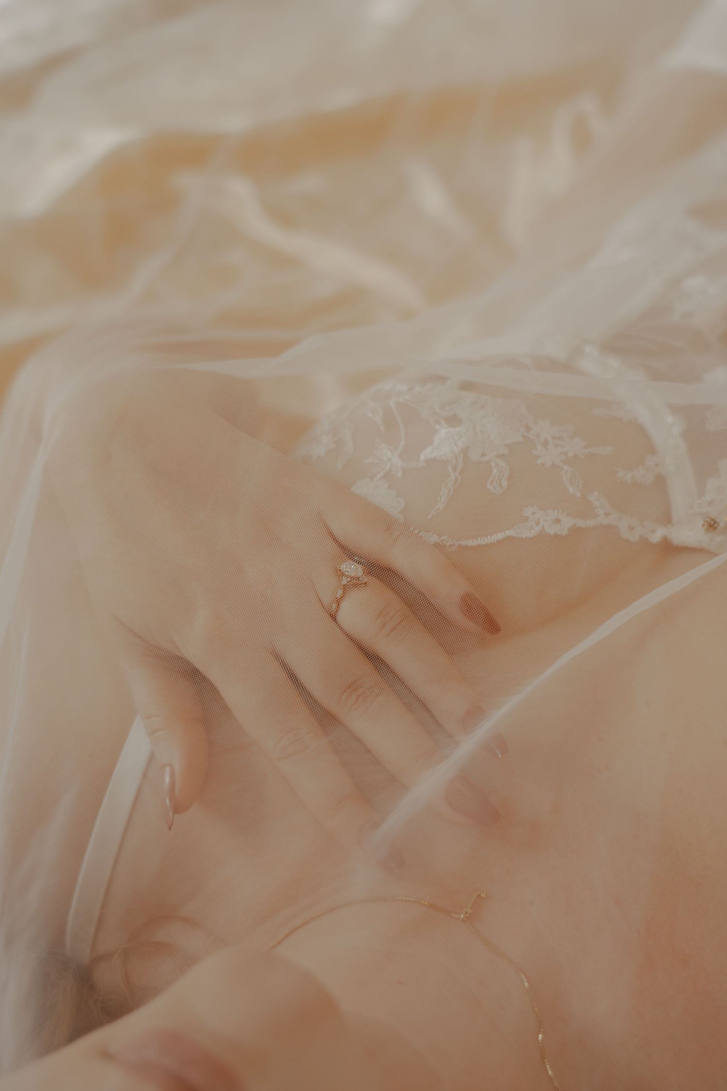 Black and white boudoir photo series showing a person reclining on white bedding.