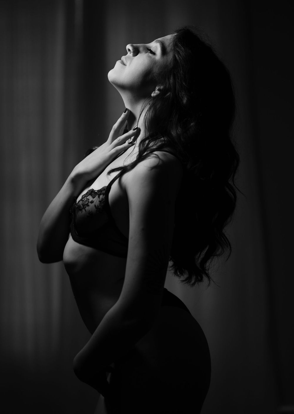 Silhouetted boudoir poses captured in dramatic black and white photography.