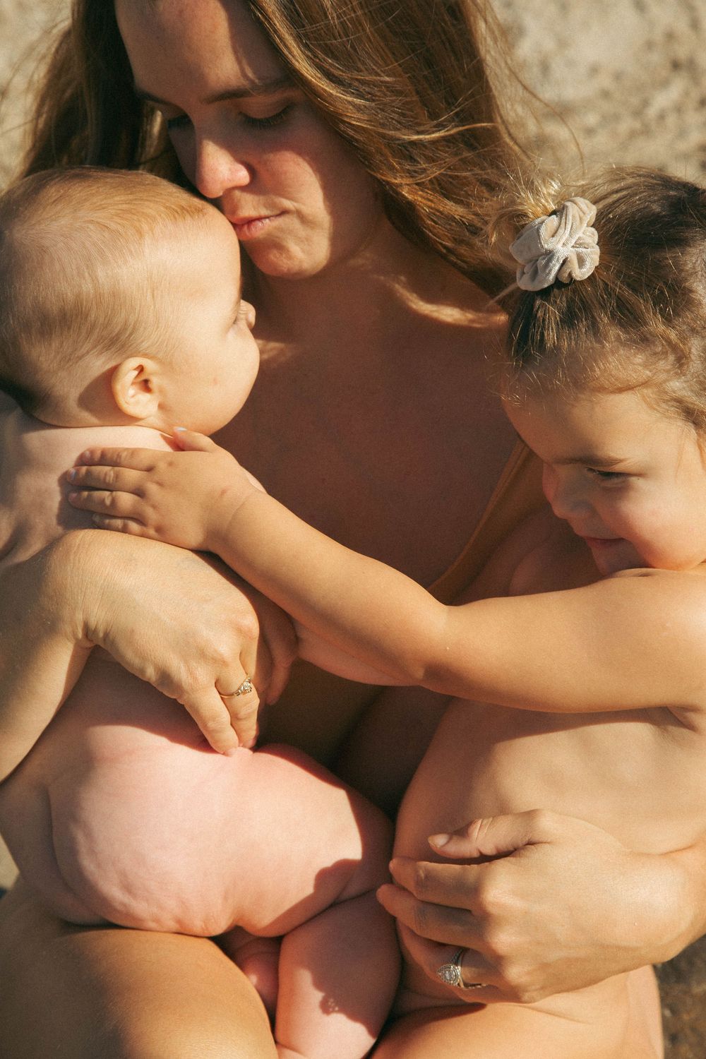 A tender moment between a mother and baby showing gentle skin-to-skin contact and nurturing care.