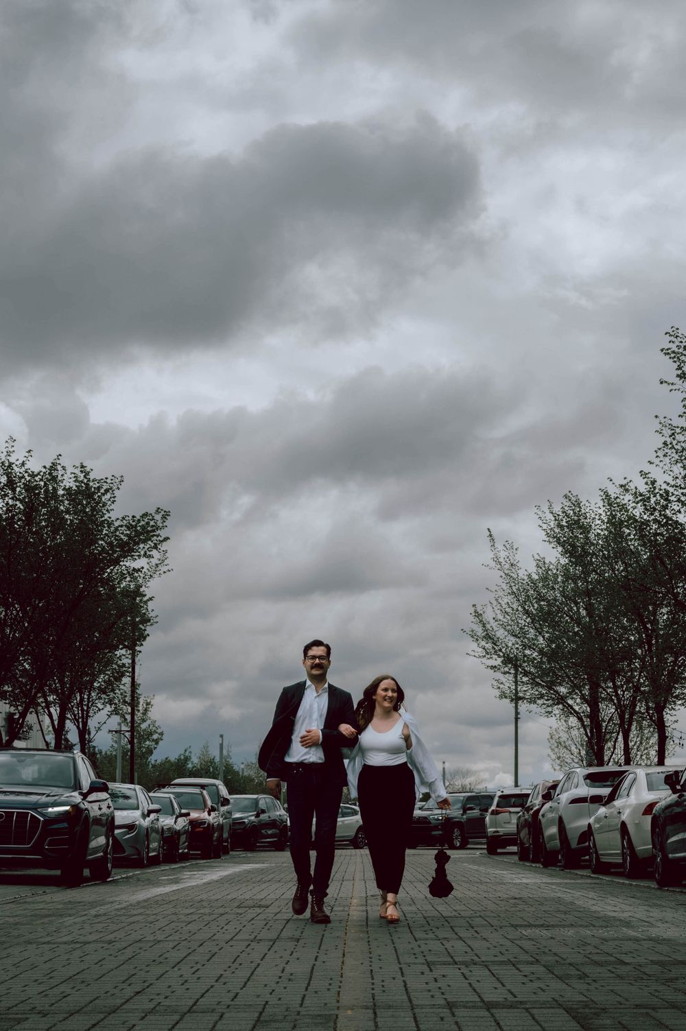 Engagement Photography - Couple walking down the street. Documentary style image.