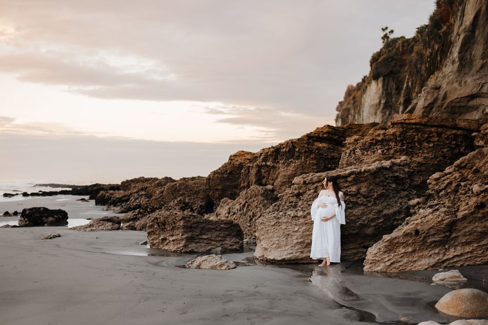 Maternity portrait of expectant mother during golden-hour at beach Westport NZ