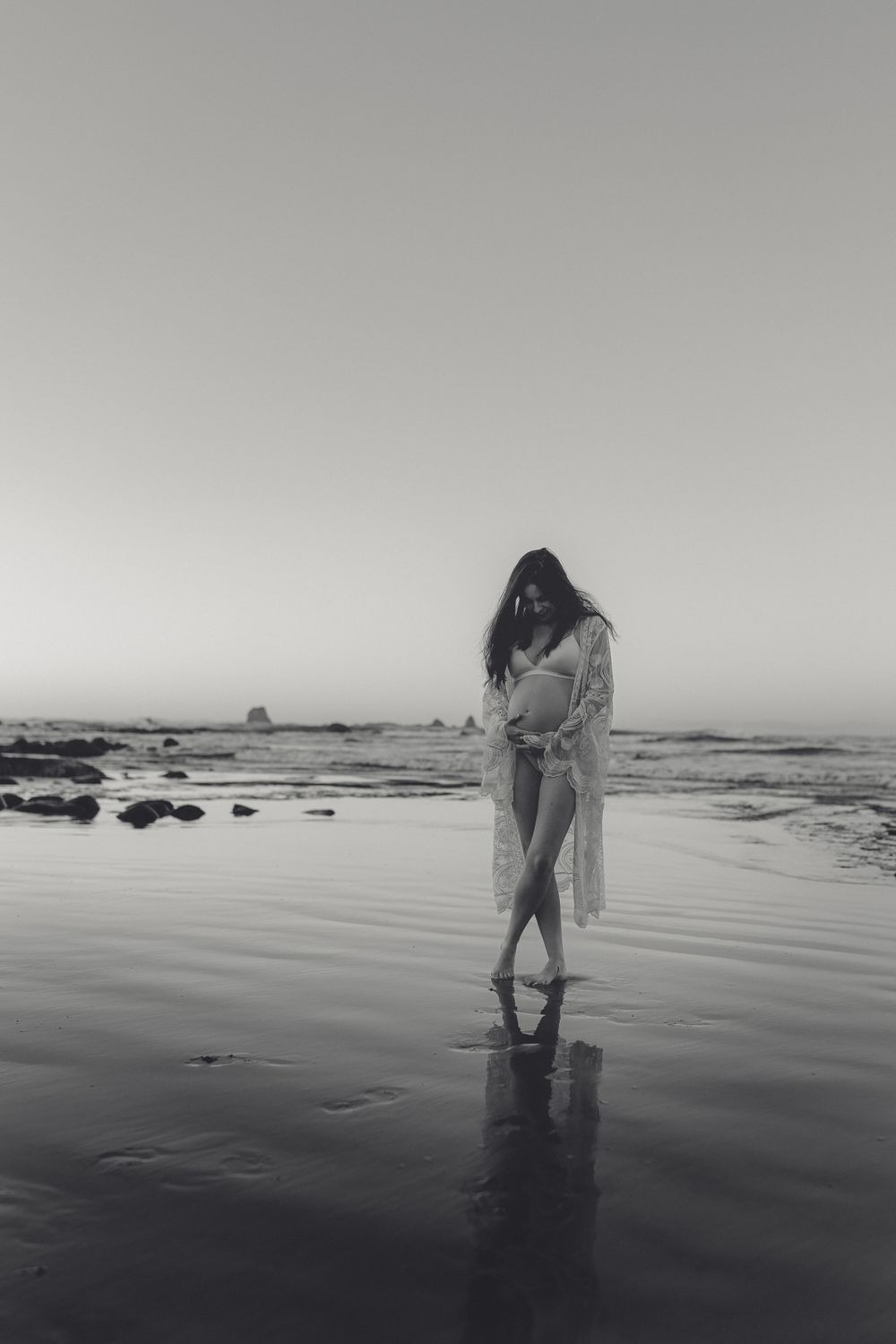 Maternity portrait of expectant mother during golden-hour at beach Westport NZ
