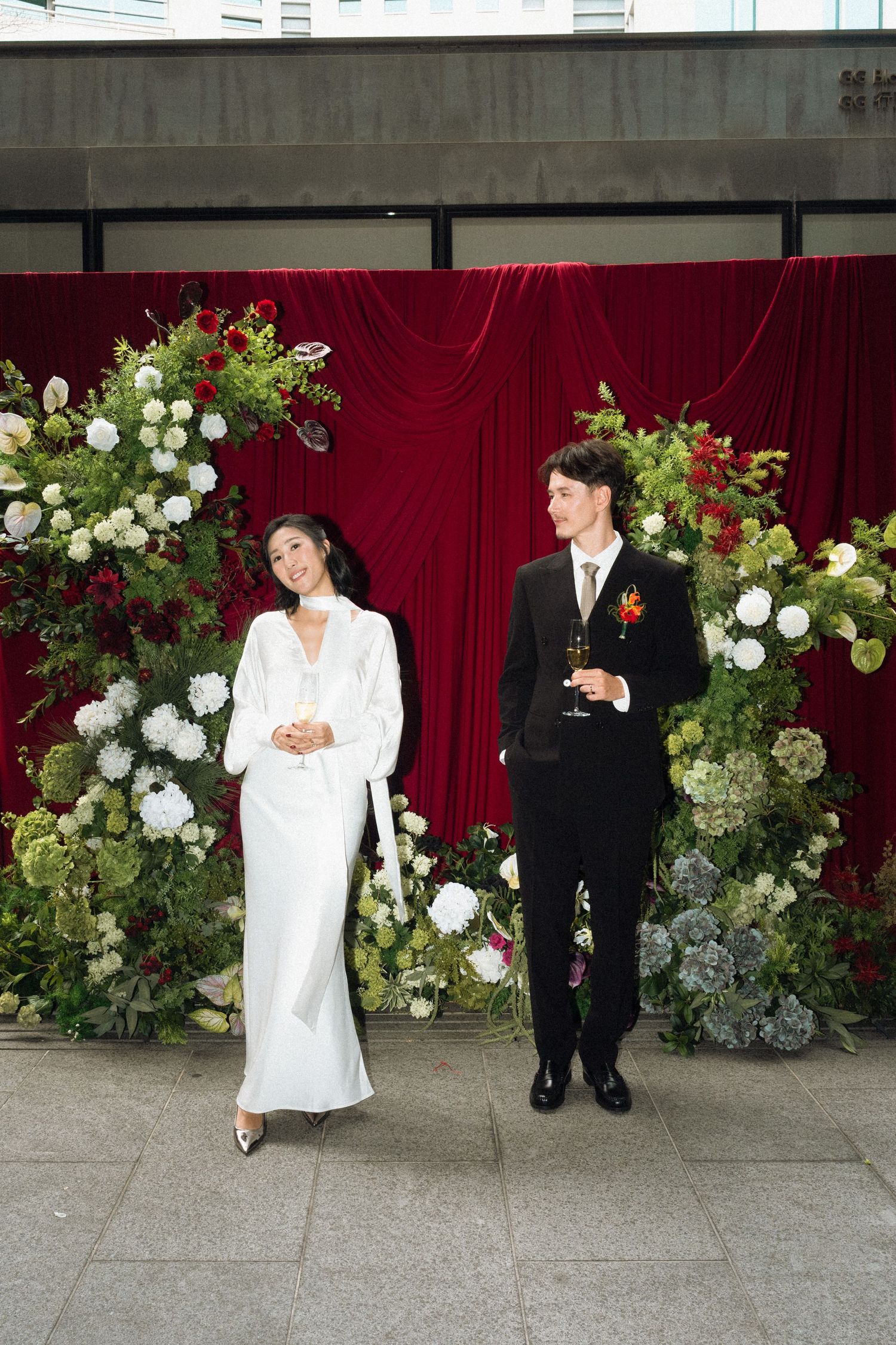 Wedding ceremony setup with circular floral arch decorated in peach and white roses.