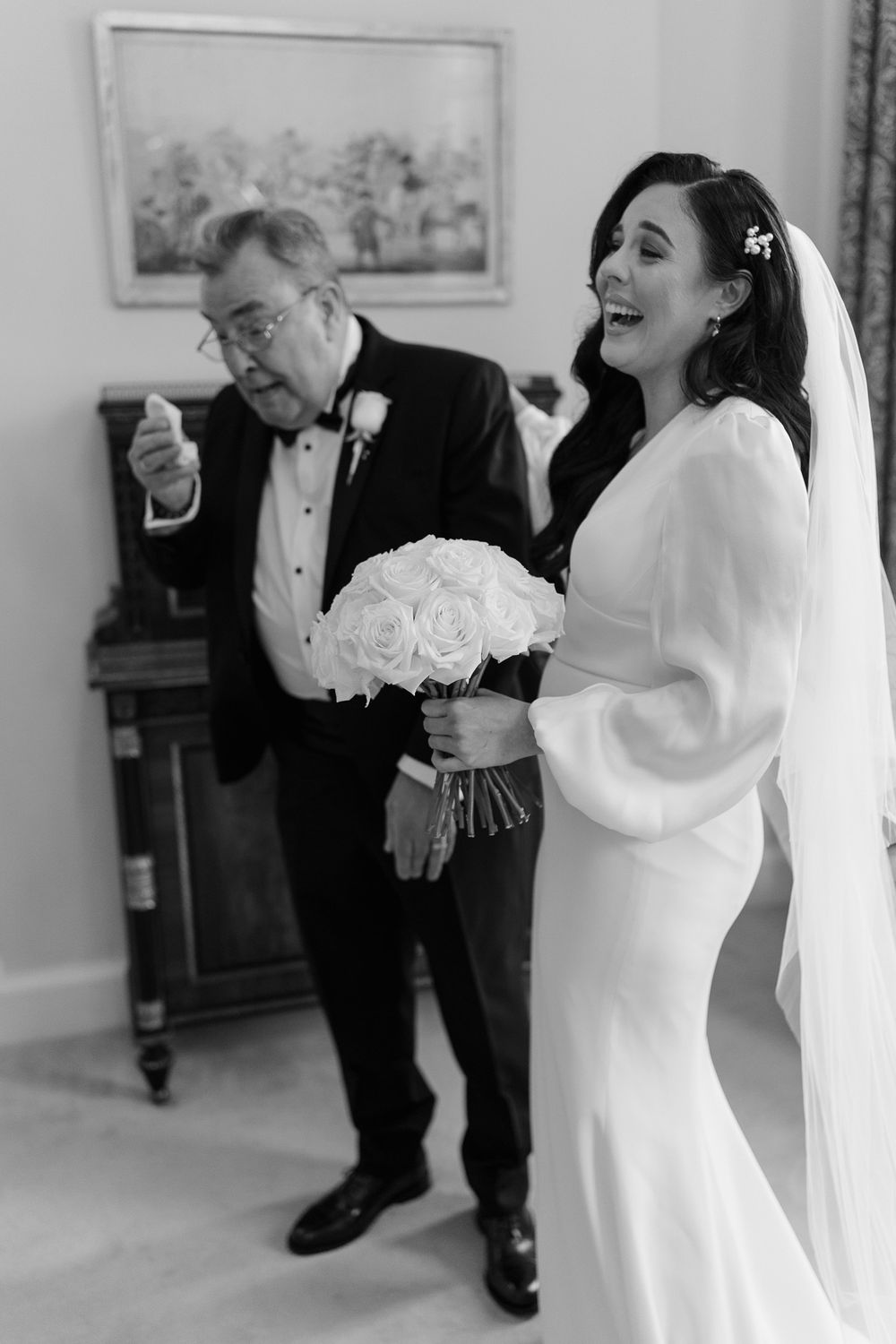 Black and white candid moment with beautiful white rose bouquet.