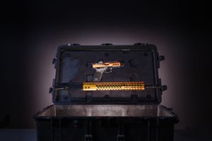 Dark moody product photography of gun cases with dramatic lighting.