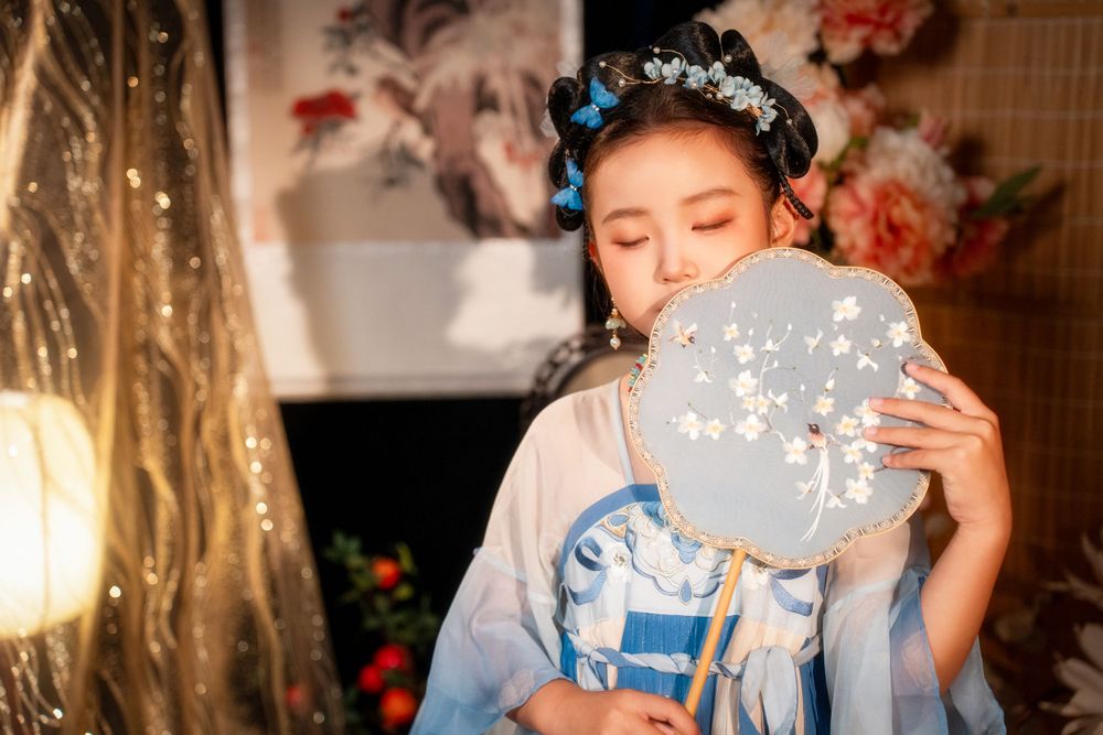 Cute children's studio portrait in an elegant Tang Dynasty Hanfu with dazzling golden props, by Imagine Image Studio.