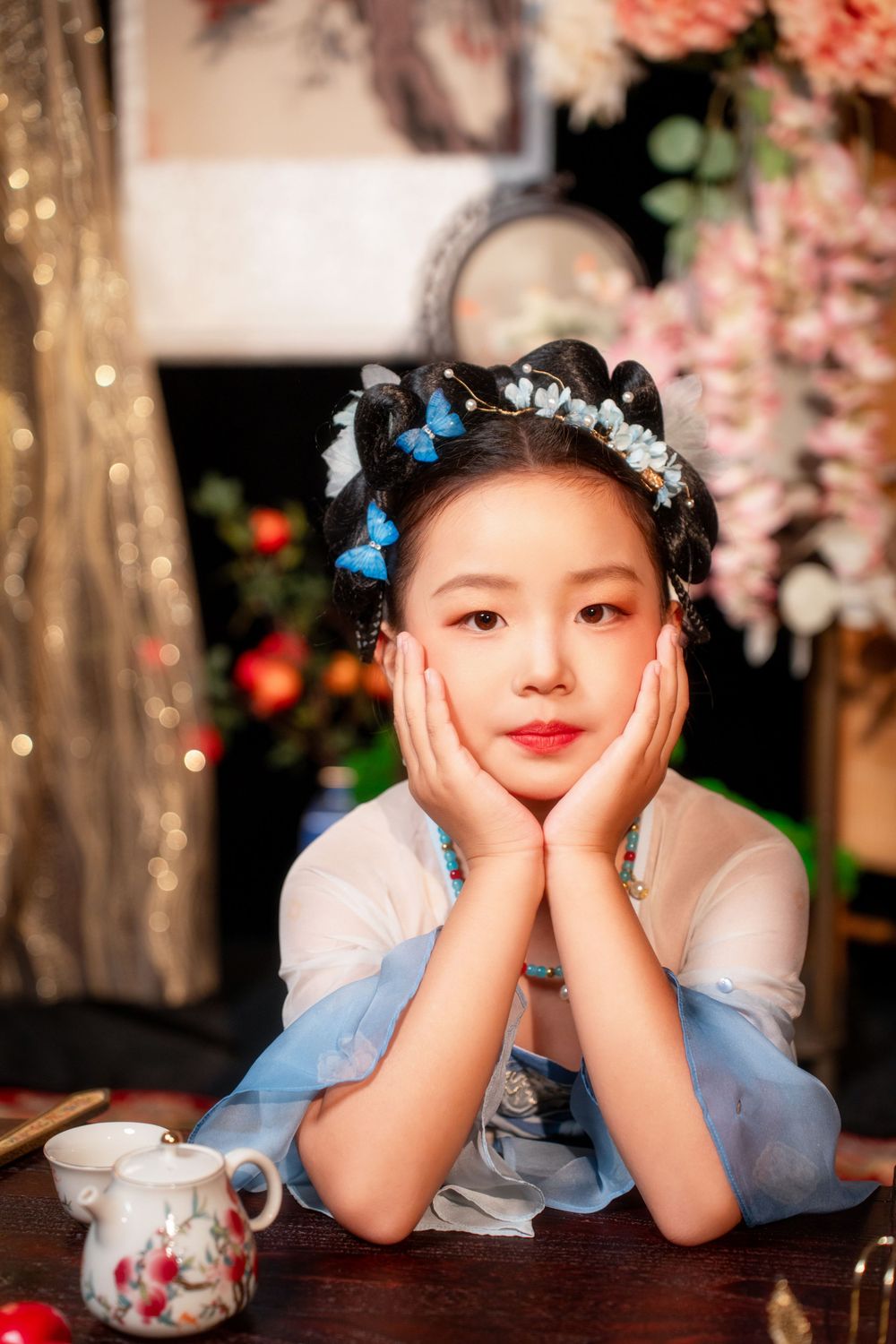 Cute children's studio portrait in an elegant Tang Dynasty Hanfu with dazzling golden props, by Imagine Image Studio.