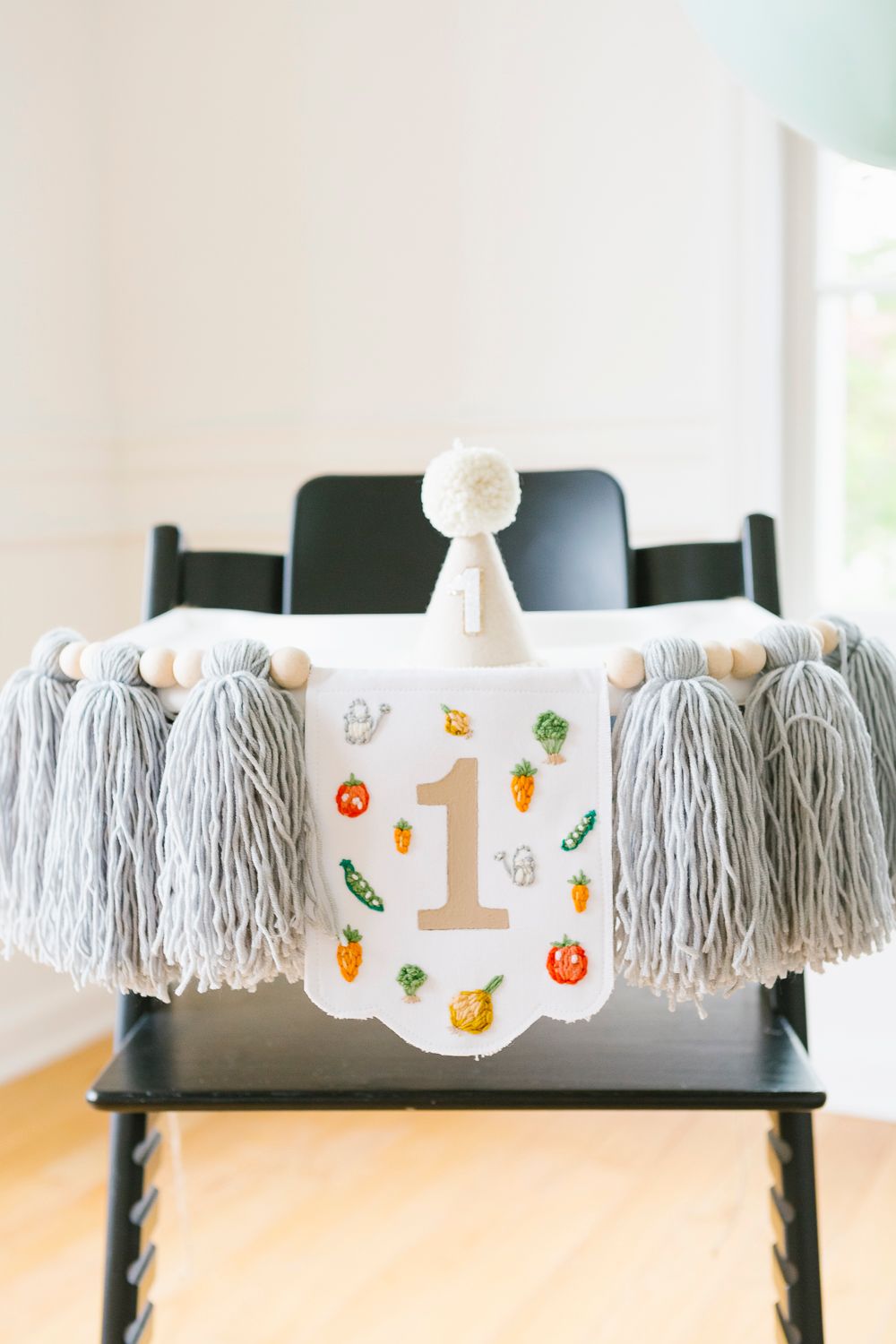 High chair decorated with cute banner and birthday hat, taken by NYC family photographer Paula Ortiz