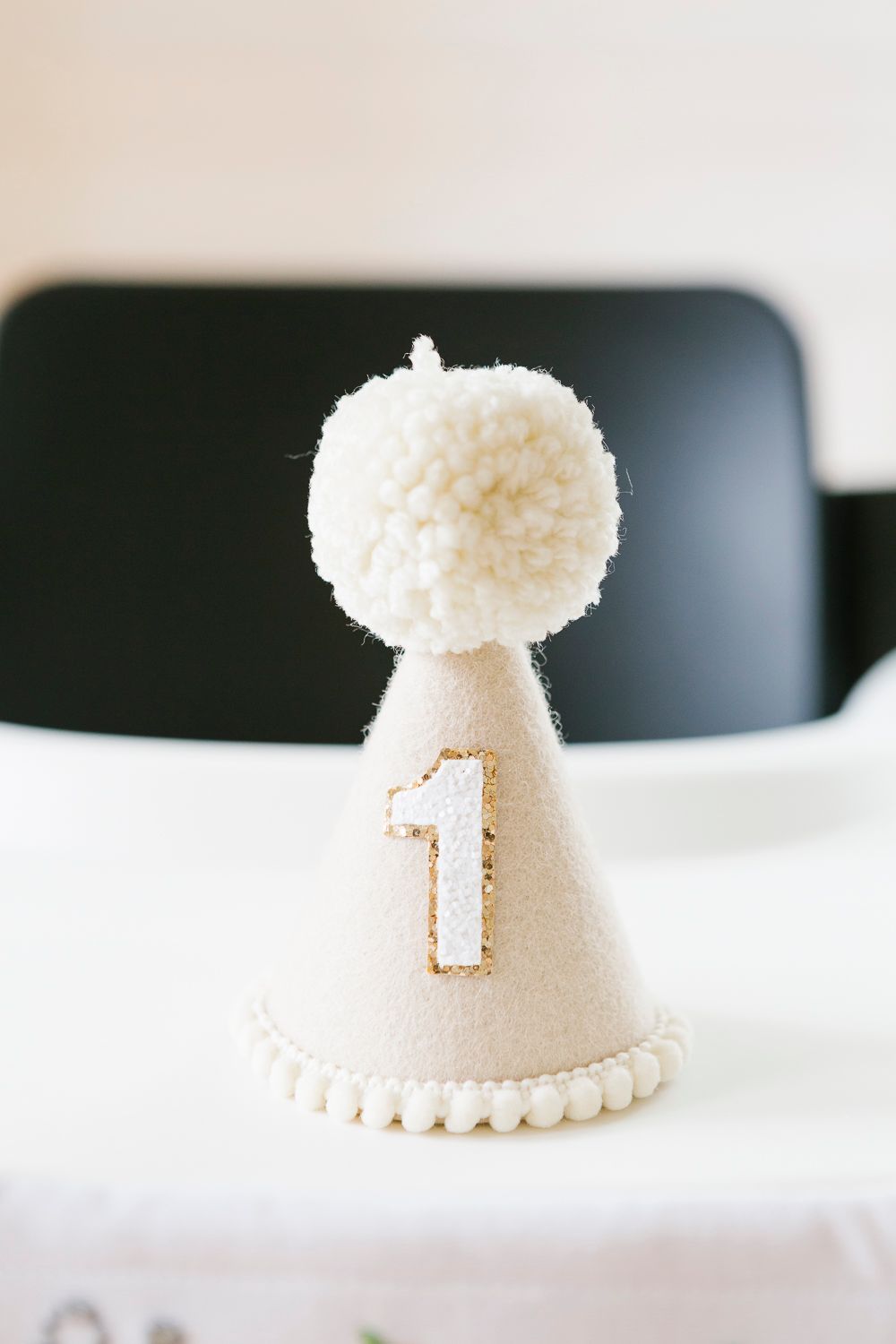Beige birthday hat with number 1 detail, taken by NYC family photographer Paula Ortiz