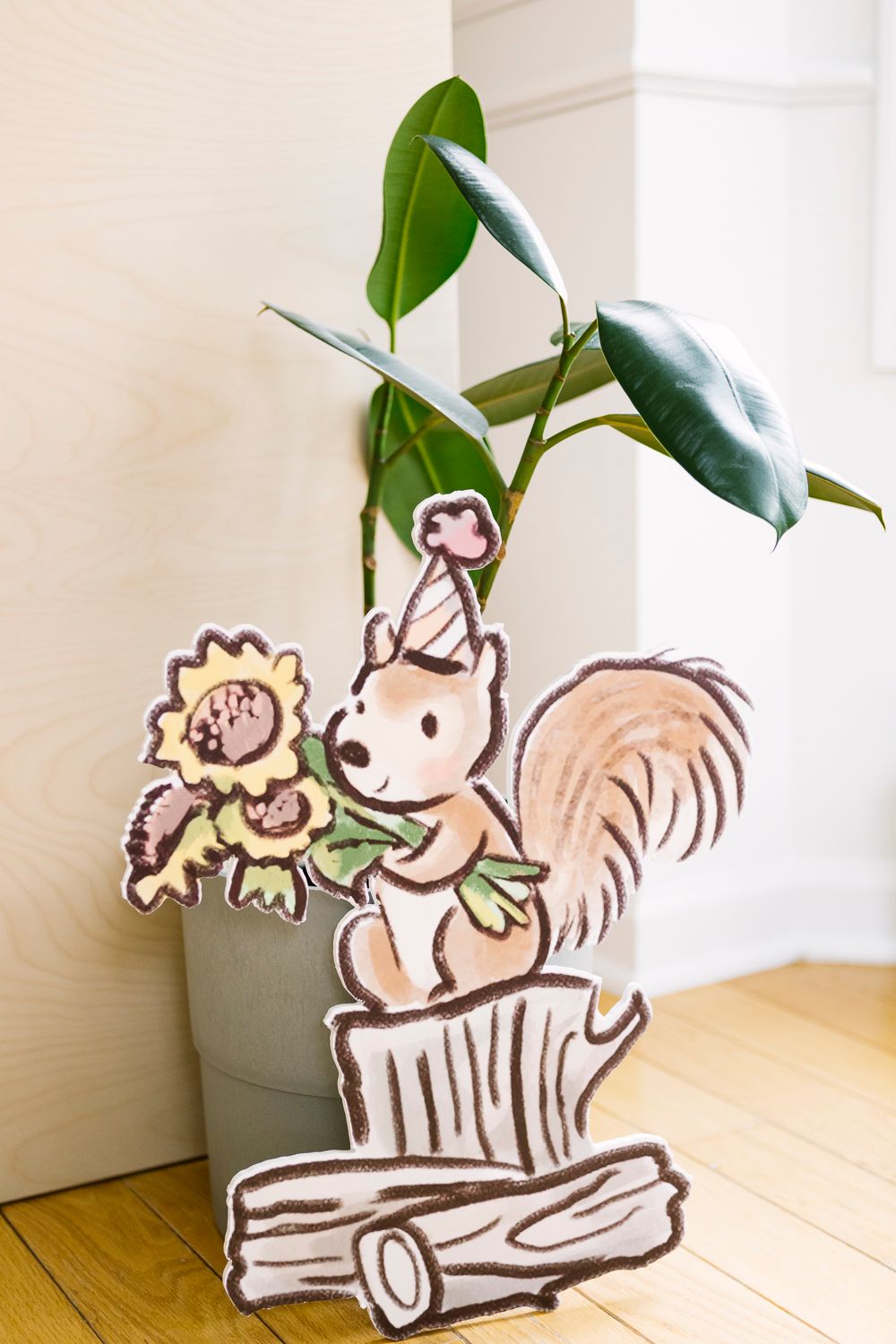 Hand-drawn squirrel cutout holding flowers, taken by NYC family photographer Paula Ortiz