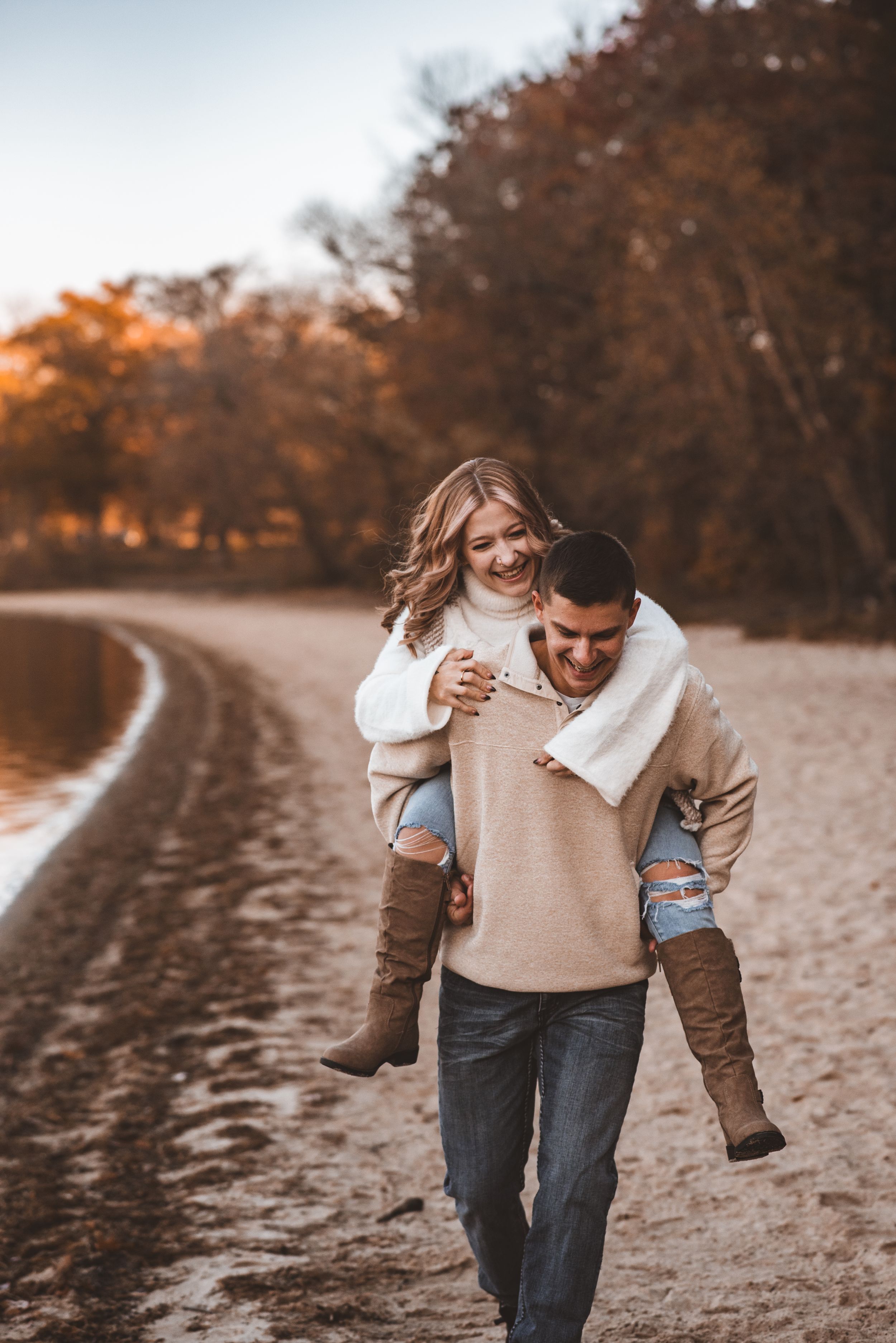 A playful piggyback ride along a winding lakeside path during golden hour sunset.