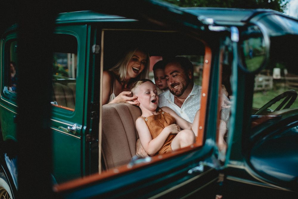 Intimate moment shared inside classic vintage automobile at sunset.