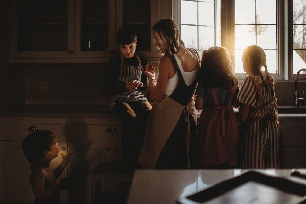 Sunlight streams through windows into a cozy kitchen during a baking session.