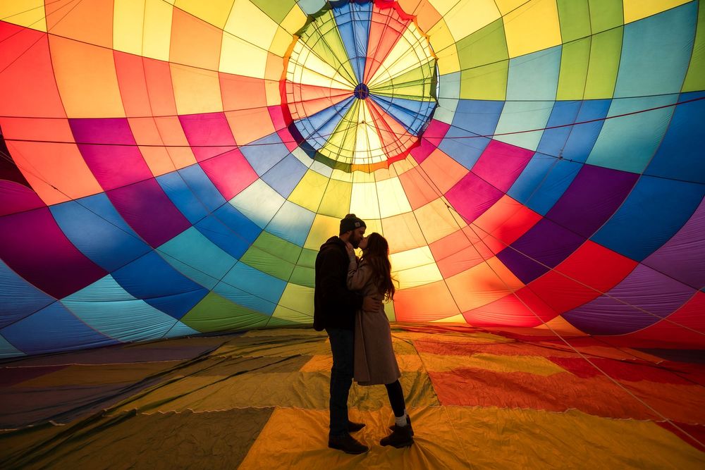 Inside view of a colorful hot air balloon canopy showing vibrant rainbow engagement photos. Albuquerque New Mexico