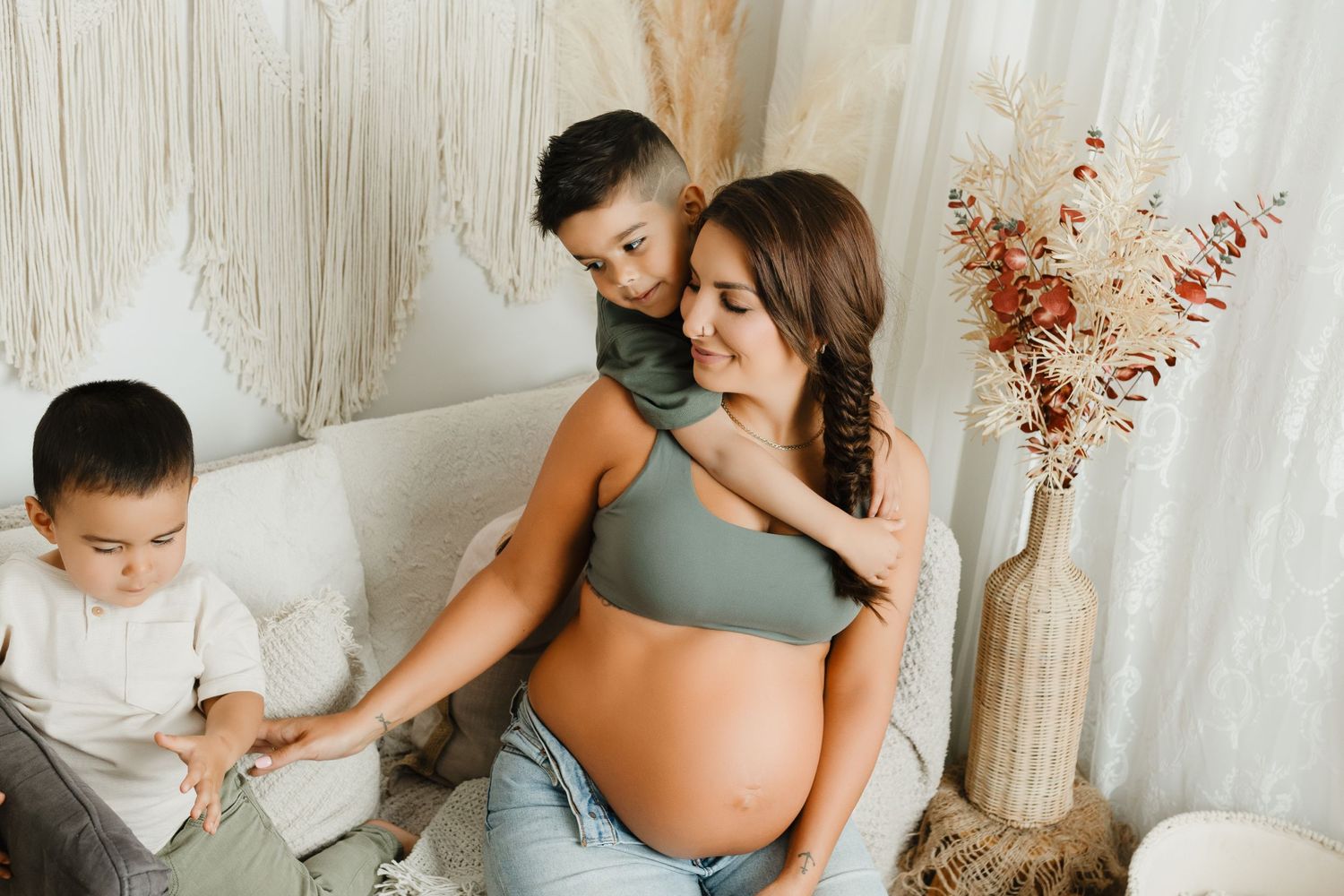 Candid maternity session with couple sharing intimate moments.