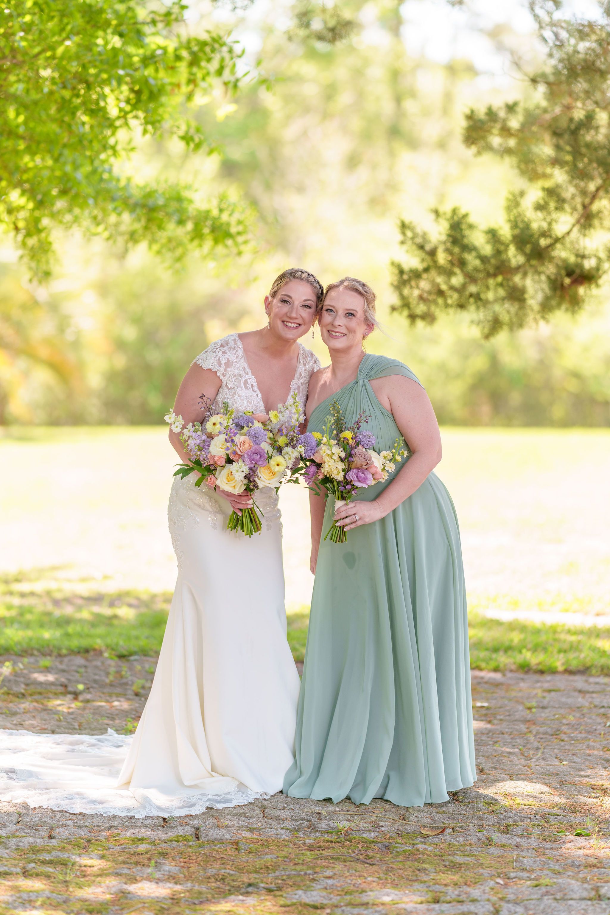 Wedding party portrait outdoors in natural sunlit setting.