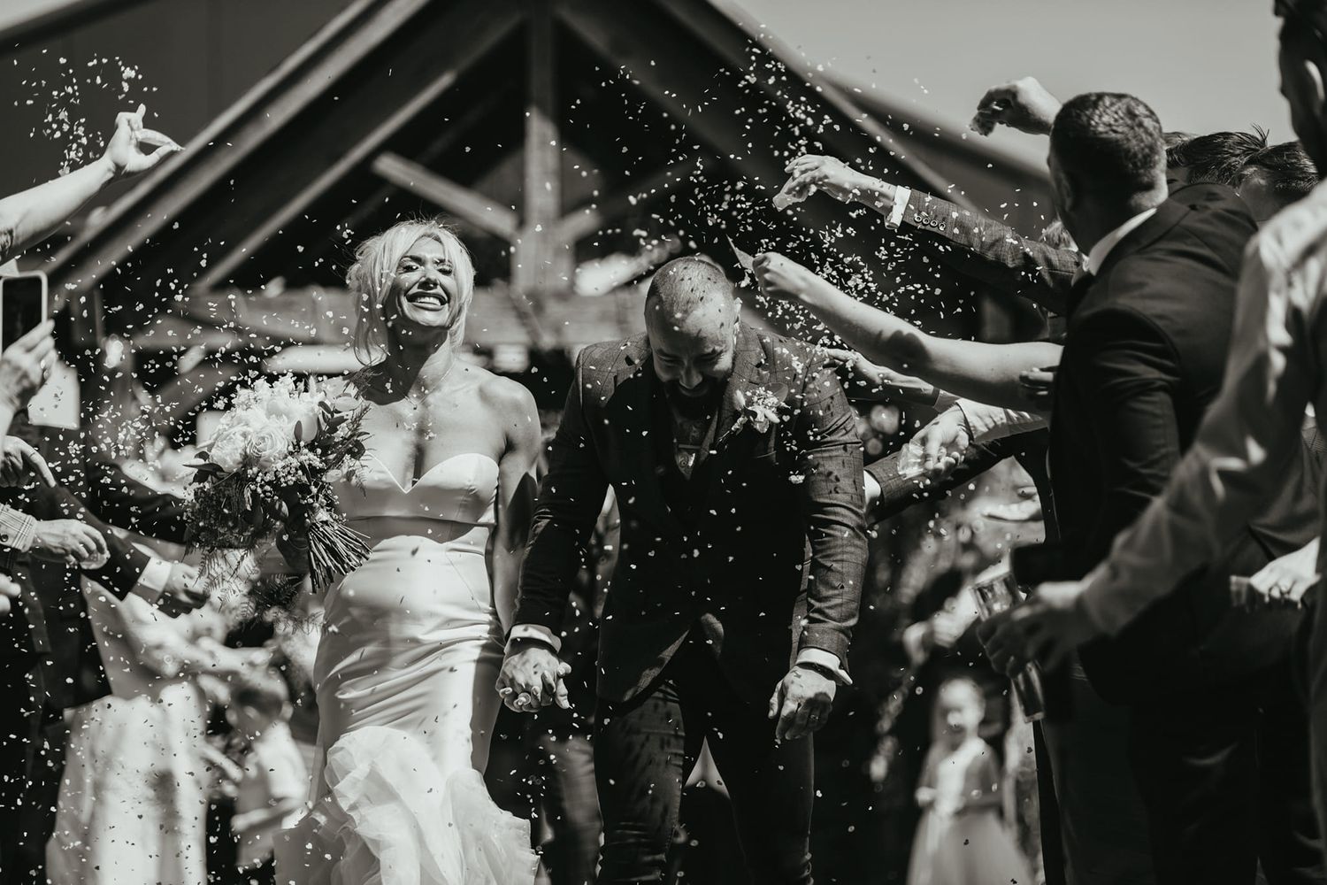 Black and white photo of celebratory moments with confetti falling at a wedding reception. Bunny Hill