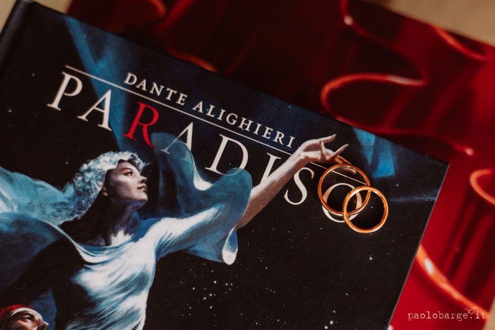 Copy of Dante's Paradise book photographed against red fabric background.
