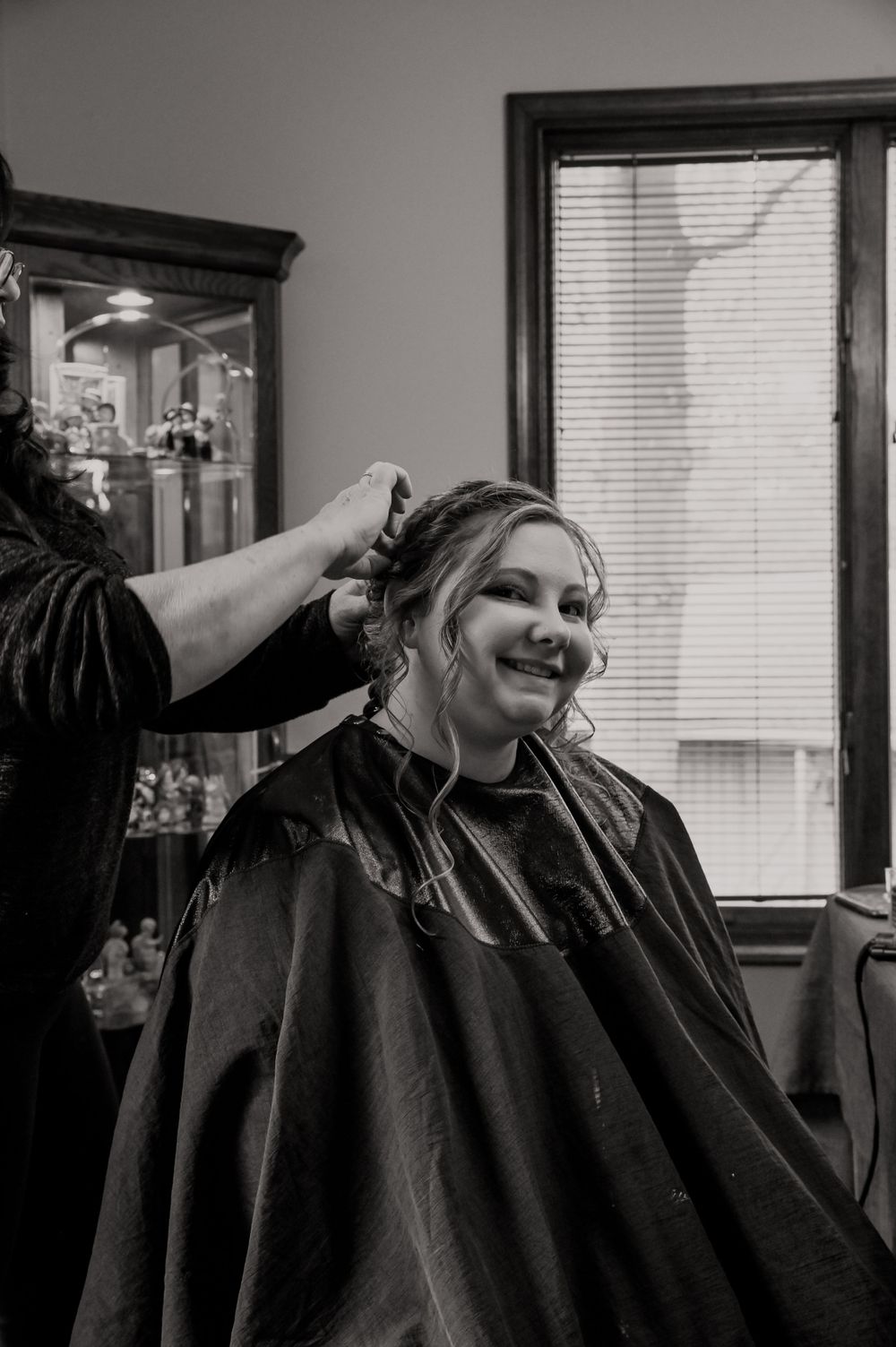 Black and white photo of wedding day hair styling preparation.