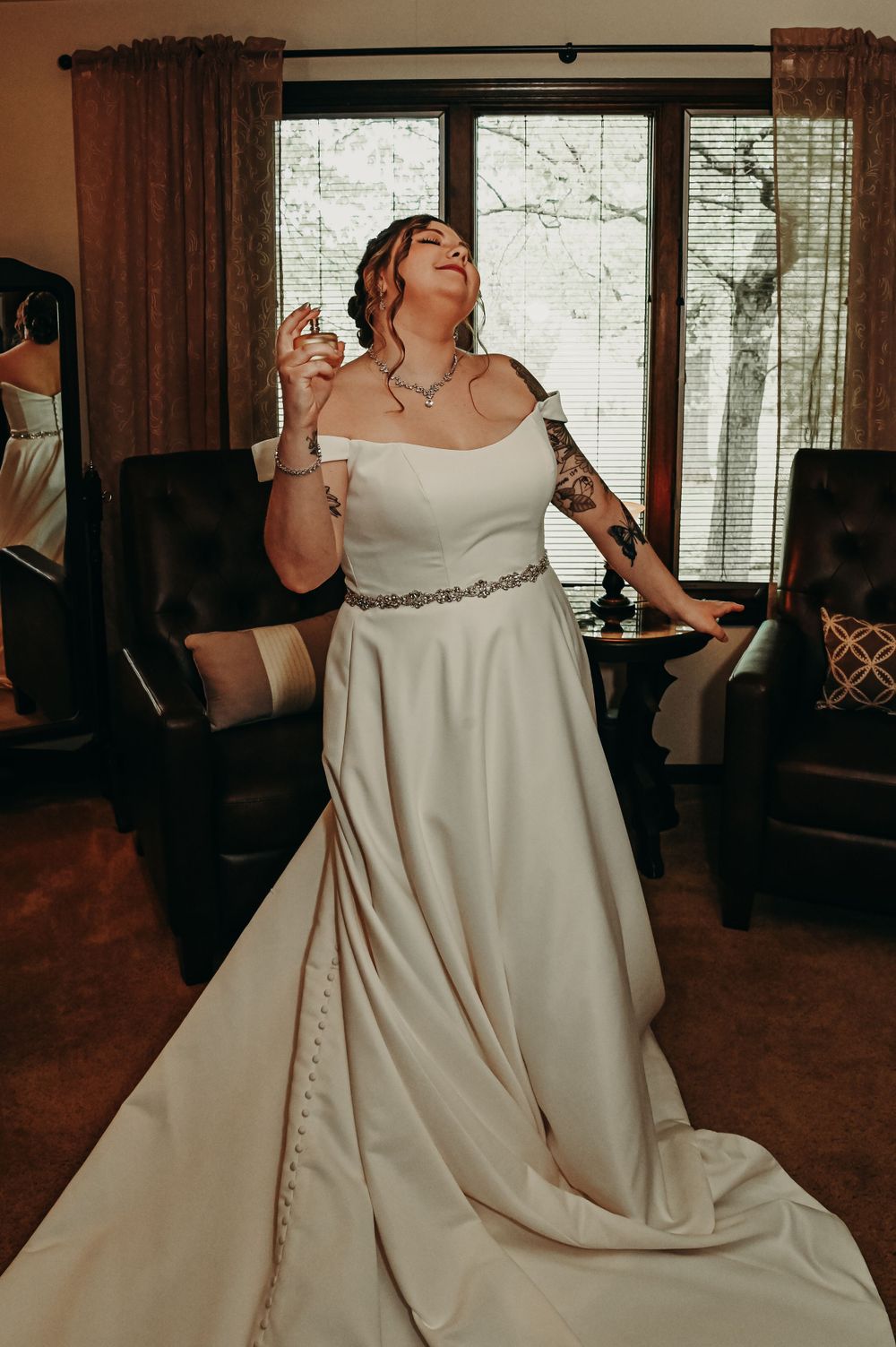 Elegant white wedding gown with flowing skirt captured in indoor lighting.