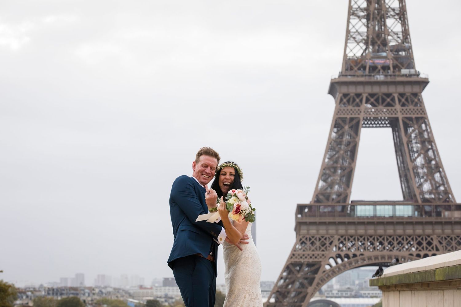 At Trocadero, Paris, a couple very happy showing their ring fingers, as they just engaged, captured by Julien LB images